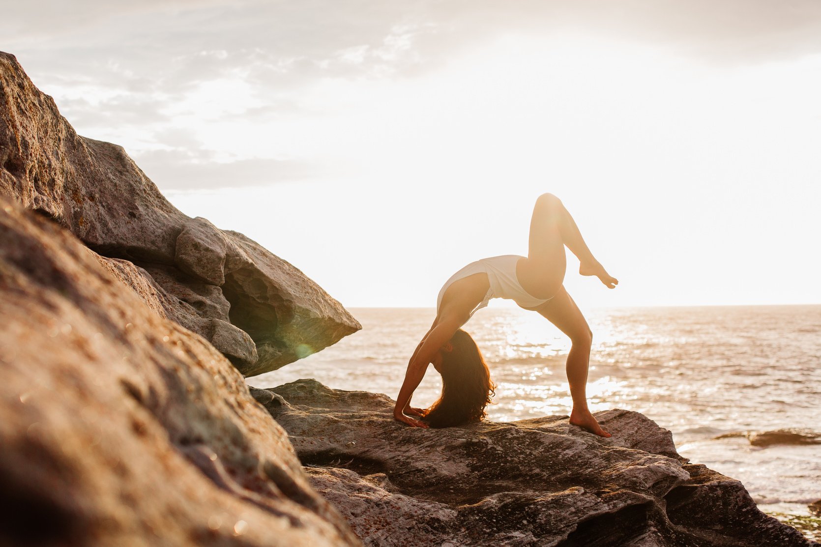 Woman Doing Yoga on Rock